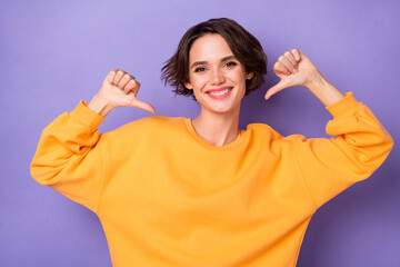 Photo of pretty positive lady point thumb fingers self herself toothy smile isolated on violet...