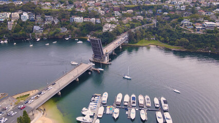 Aerial drone view of Spit Bridge across the Middle Harbour at The Spit between Mosman and Seaforth, Sydney, NSW, Australia raised to allow boats to pass through   