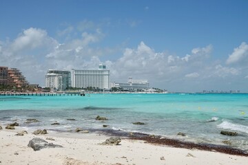 Fototapeta premium Caribbean beach with turquoise sea water and beautiful view on Hotel Zone at Cancun, Quintana Roo, Mexico. Paradise, Vacations and tourism concept. High quality photo