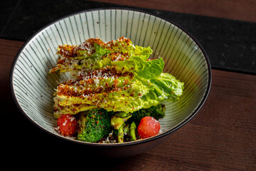 Salad with broccoli, parmesan, lettuce, tomatoes