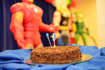 cake with star candles on children's birthday party table
