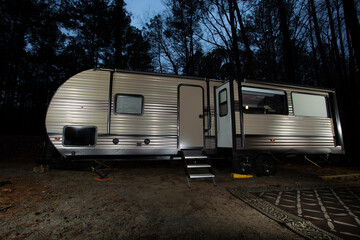 Night camping trailer in a forest