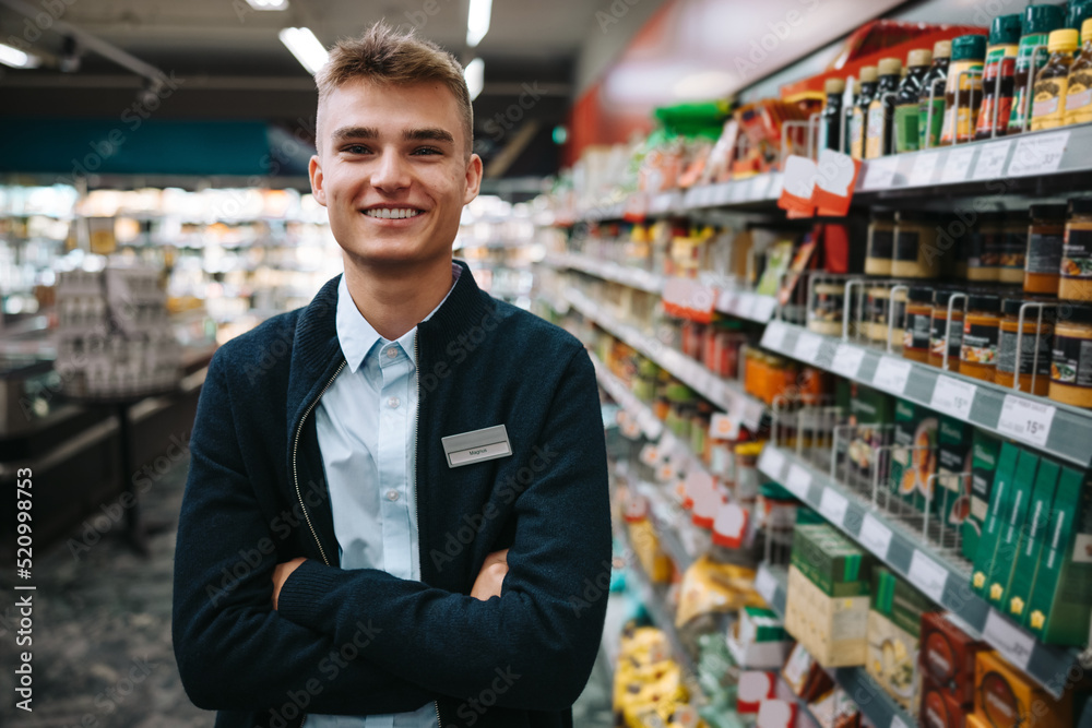 Wall mural young grocery store worker