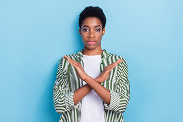 Portrait of attractive girl crossed hands showing stop sign isolated over bright blue color...