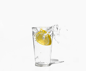 glass of clear water with a splash of lemon