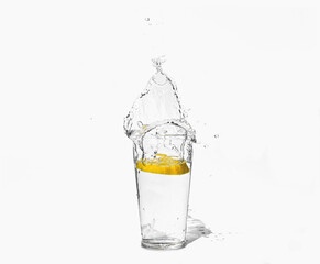 glass of clear water with a splash of lemon