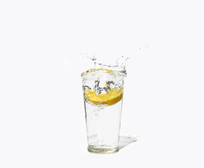 glass of clear water with a splash of lemon