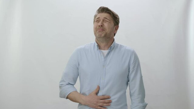 The hungry man looks at a spot on the left of the screen and is surprised. Creative people can put whatever they want where the man is looking. Surprised hungry man looking at empty advertising space.