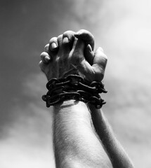 Chained hands praying for help - obrazy, fototapety, plakaty