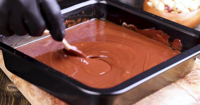 making chocolate from high-quality cocoa and cocoa butter with sugar, mixing hot chocolate during its preparation