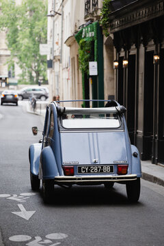 Paris, France - May 31, 2022: Vintage Citroen 2cv on the narrow urban streets of the old city - restored car