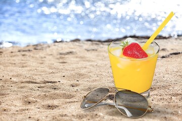 Fresh tropical cocktail on beach with sand. Summer sea vacation and travel concept. Exotic summer drinks.