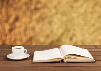 Retro antique journal with paper pages with a cup of tea on rustic wood
