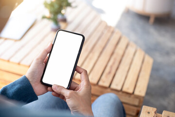 cell phone blank white screen mockup.hand holding texting using mobile on desk at office.background empty space for advertise.work people contact marketing business,technology
