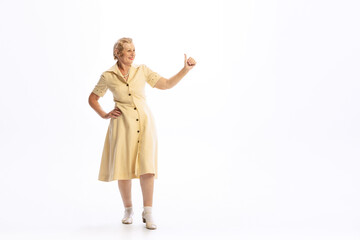 Portrait of beautiful senior woman in retro vintage style outfit posing isolated on white background. Concept of beauty, old generation, fashion, emotions