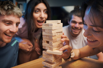 Young people playing Jenga together