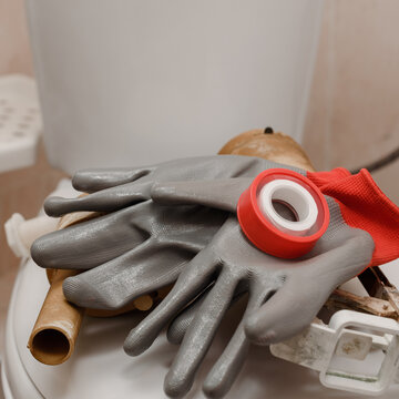 Closeup Photo Of Plumbing Tools Lying On Toilet Seat Lid