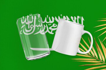 Patriotic can glass and mug mock up on background in colors of national flag. Saudi Arabi