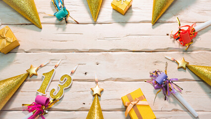 Beautiful colorful card on the background of white boards happy birthday in golden hues copy space. Beautiful ornaments and decorations of gold color festive background. Happy birthday number 13
