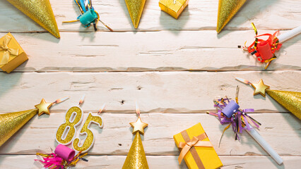 Beautiful colorful card on the background of white boards happy birthday in golden hues copy space. Beautiful ornaments and decorations of gold color festive background. Happy birthday number 85