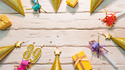 Beautiful colorful card on the background of white boards happy birthday in golden hues copy space. Beautiful ornaments and decorations of gold color festive background. Happy birthday number 89