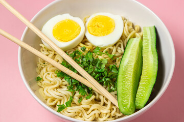Portion of noodles with a boiled egg on a pink background. Traditional oriental food. instant noodles