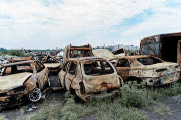 Burned civilian car. Stacked vehicles. War in Ukraine, Bucha