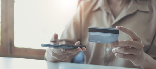 Woman hands holding smartphone shopping online with credit card. Online Payment. Online shopping concept.