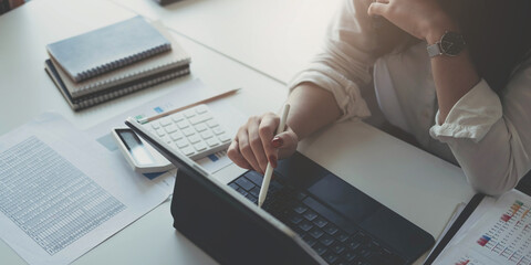 Businesswoman using laptop computer keyboard at the office.