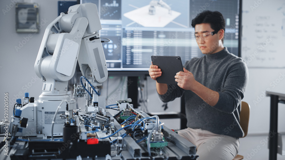 Aufkleber Student Using Tablet to Controll Robotic Hand. Bionic Arm Moving in Different Directions During University Class. Asian Man Developing Software For Robotics Facility. Computer Science Concept.