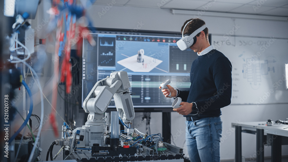 Poster student engineer wearing virtual reality headset holding controllers and moving bionic claw under hi