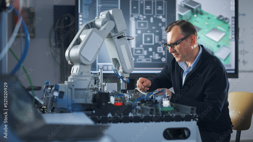 Leinwandbilder Portrait of Smiling Engineer Using Screwdriver while Working with Microchip of Robotic Arm. Man Looking at Camera During his Experiment with Bionic Hand. High-Tech Science and Engineering Concept