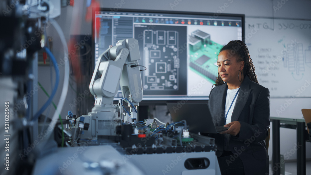 Poster Black Female Developer Controls Robot Hand with Laptop, while Writing Code at Computer Science Research Laboratory. High-Tech Science and Programming at Modern Start Up Lab Concept.