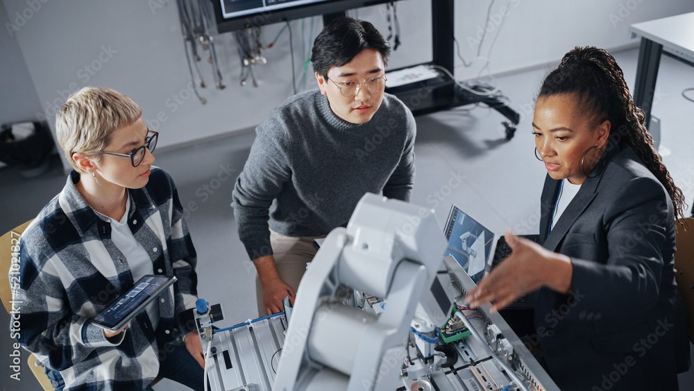 Aufkleber Diverse Students and Black Teacher Looking at Robot Hand and Discussing It While Developing Programs at Modern University. Education and Innovative Technologies Concept. High Angle View.