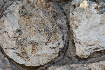 The texture of the stone wall. Stone wall closeup, background or texture. Part of a large stone for background or text