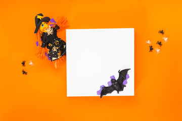 Happy Halloween background.  Background with white podium for product presentation and ornaments on orange background . Minimal concept. Top view, blank space