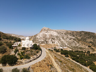 panoramic aerial shot drone on white church with background the village of FILOTI, Naxos island, greece. copy space