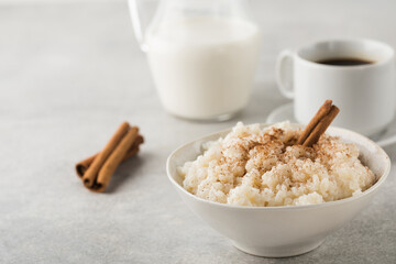  Scandinavian rice porridge in a bowl with cinnamon. Healthy breakfast.