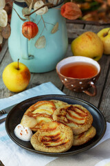 Whole wheat apple pancakes served with tea in the garden. Rustic style.