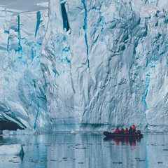 Tourists observing a glacier on the Antarctica, Paradise bay, Antartic Peninsula.