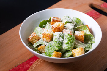 Food Concept Homemade organic classic Caesar Salad on wooden board with copy space