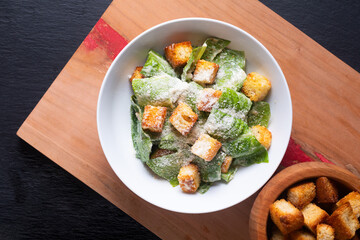 Food Concept Homemade organic classic Caesar Salad on wooden board with copy space