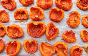 Chopped organic red tomatoes ready for drying, abstract background.Food concept.
