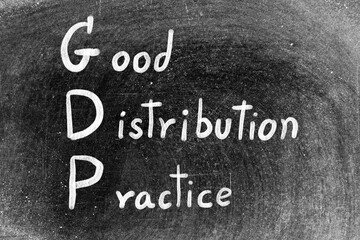 Fototapeta premium White chalk hand writing in word GDP Good distribution practice on blackboard background
