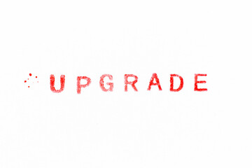 Red color ink rubber stamp in word upgrade on white paper background