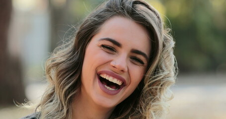 Millennial girl 20s authentic smile and laugh. Young woman laughing. Happy emotion
