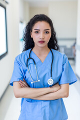 Female doctor stands at hospital. Healthcare worker. woman pharmacist with and stethoscope smiling satisfied with her job in hospital. black health professional wearing stethoscope for support Patient