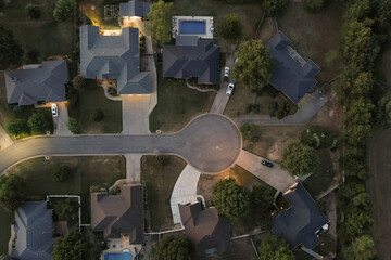 Aerial overhead view of a cul-de-sac in a suburban residential neighborhood at sunset