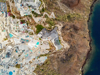 top panoramic shot drone of village of thira and oia in santorini island, greece. with coastline...