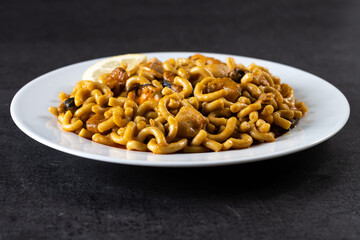 Traditional Spanish fideua. Noodle paella on black background